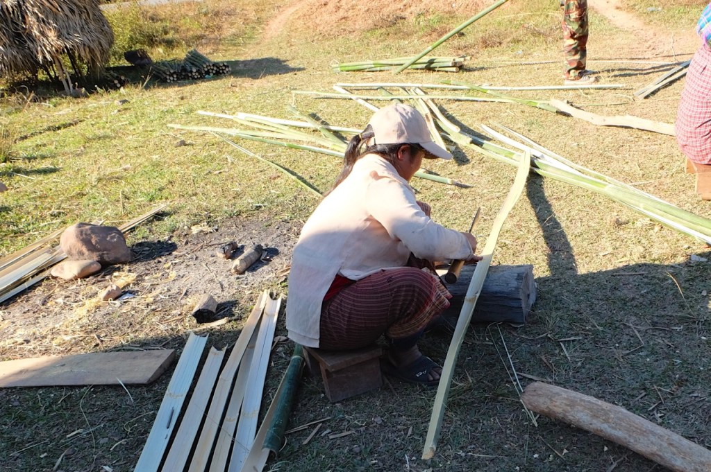 Preparing bamboo for the walls of a hut