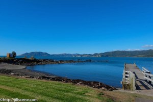 The wharf at Waihau Bay. Cape Runaway is in the far distance.